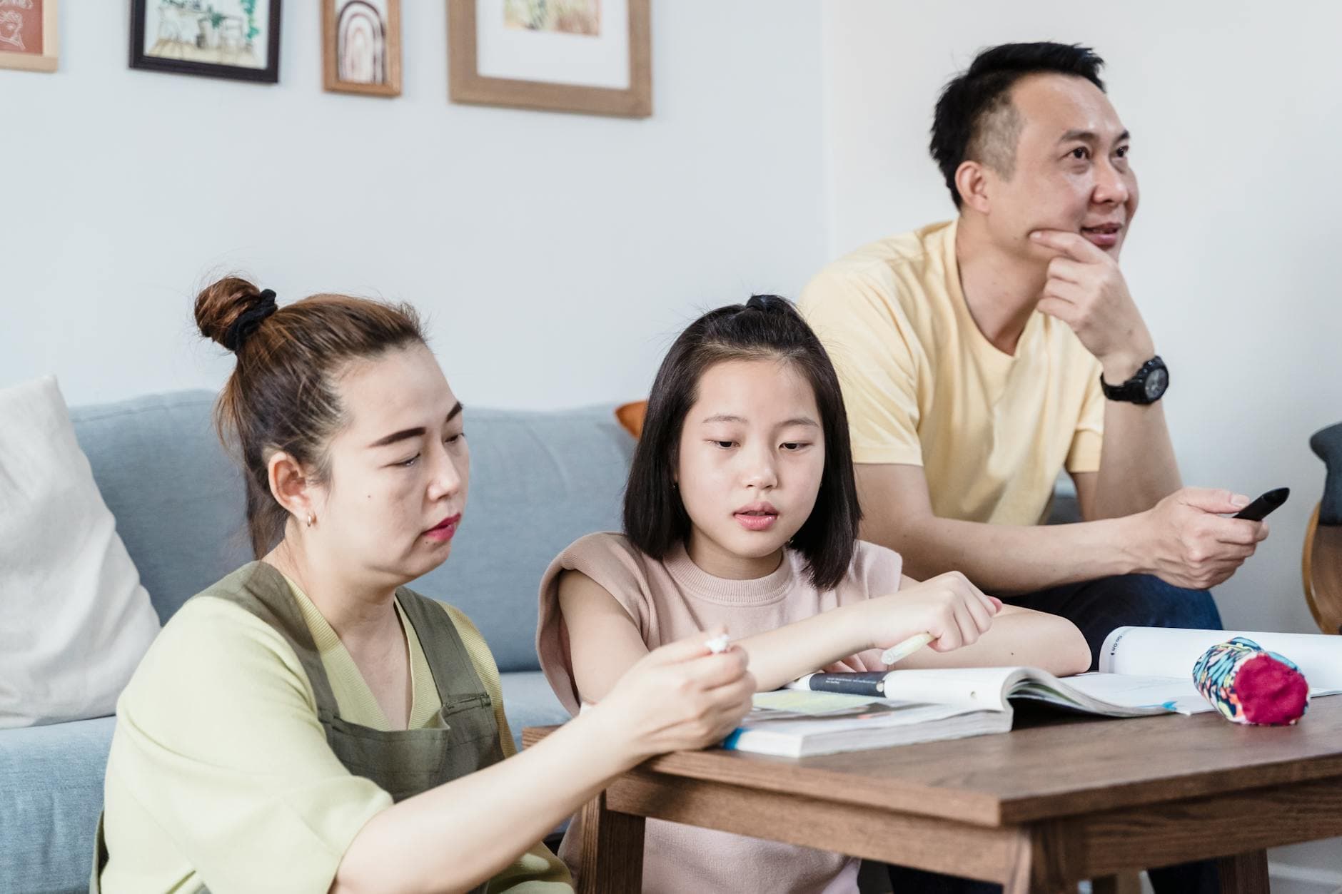 A family helping their daughter with learning activities at home